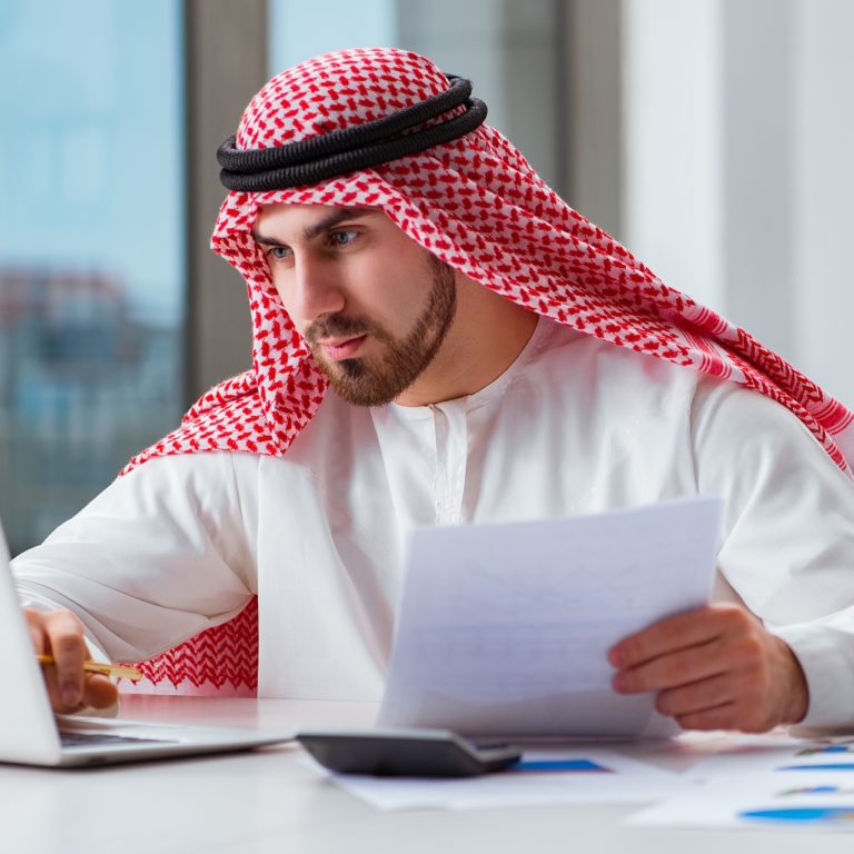 Arab translator man in front of laptop