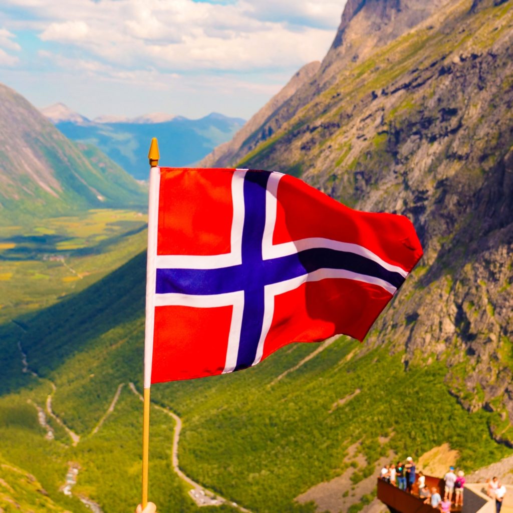flag of norway with norway fyord in background