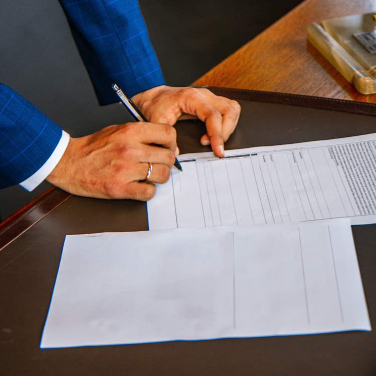 male hands signing a legal document