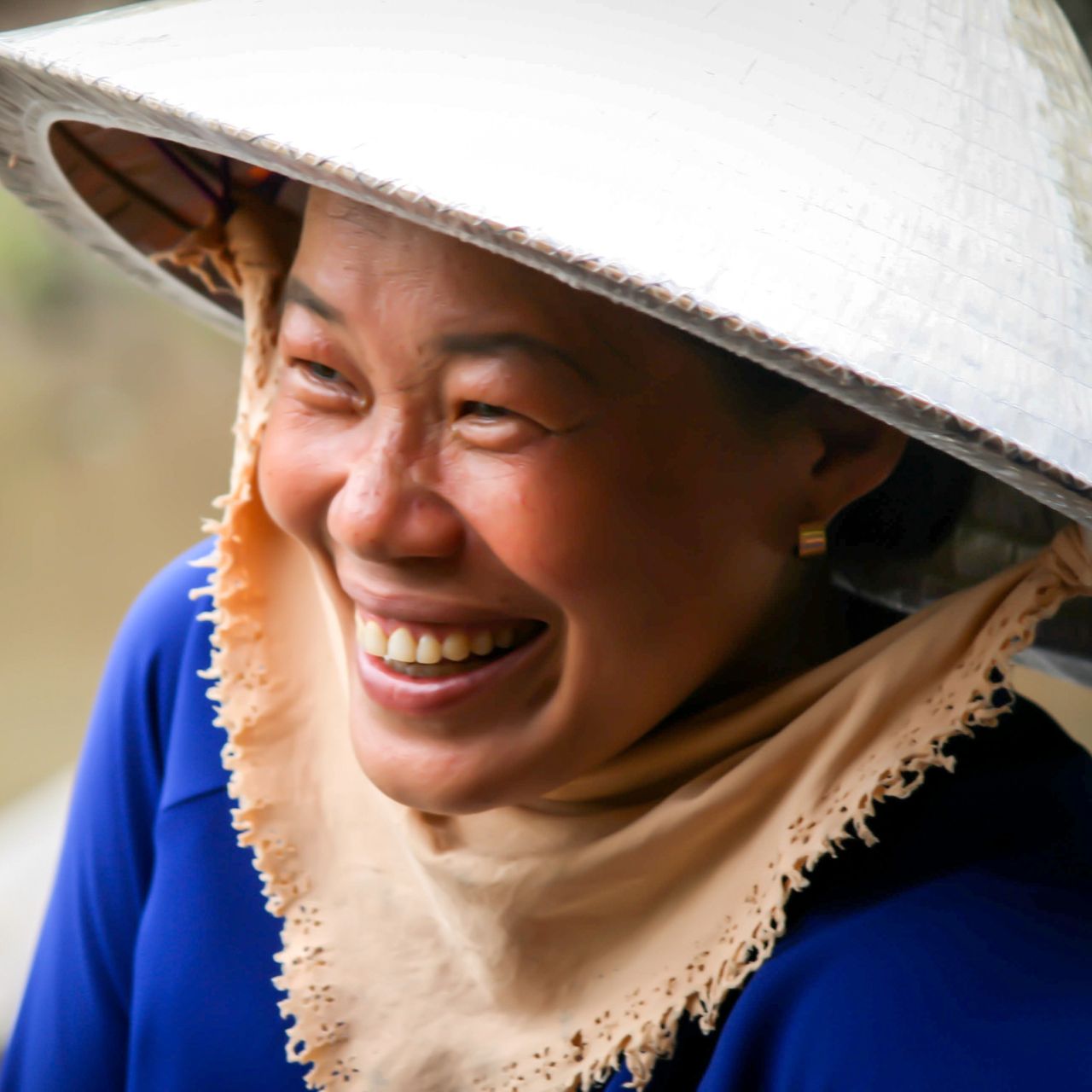 smiling vietnamese woman with traditional vietnamese hat