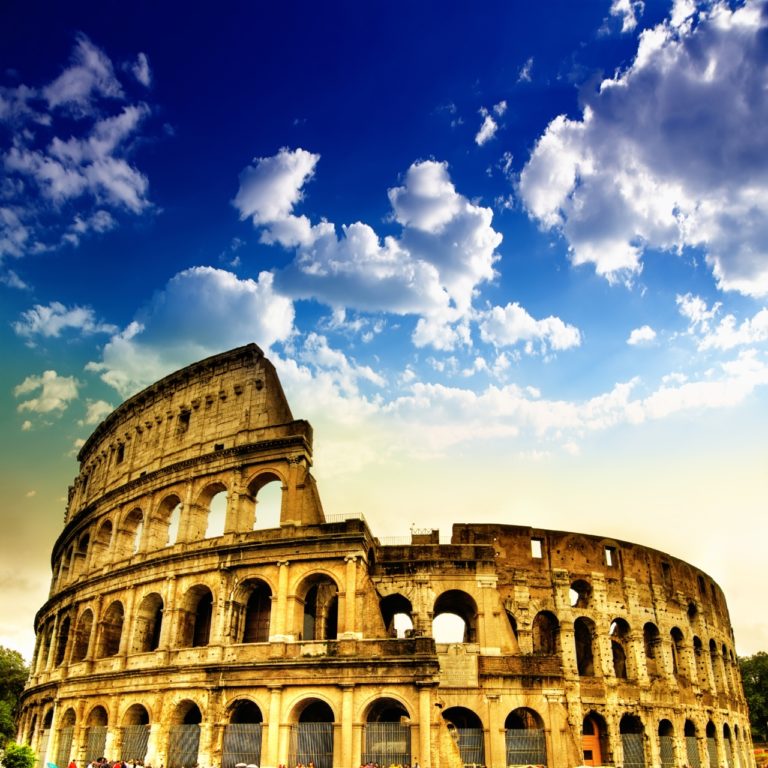 the Coliseum in Rome, Italy against blue sky