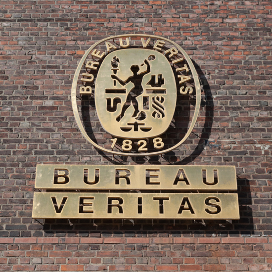 Bureau Veritas logo ISO certification body on brick wall