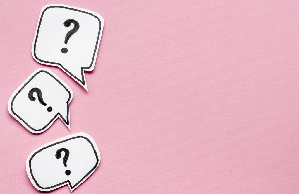 three question mark badges against pink background