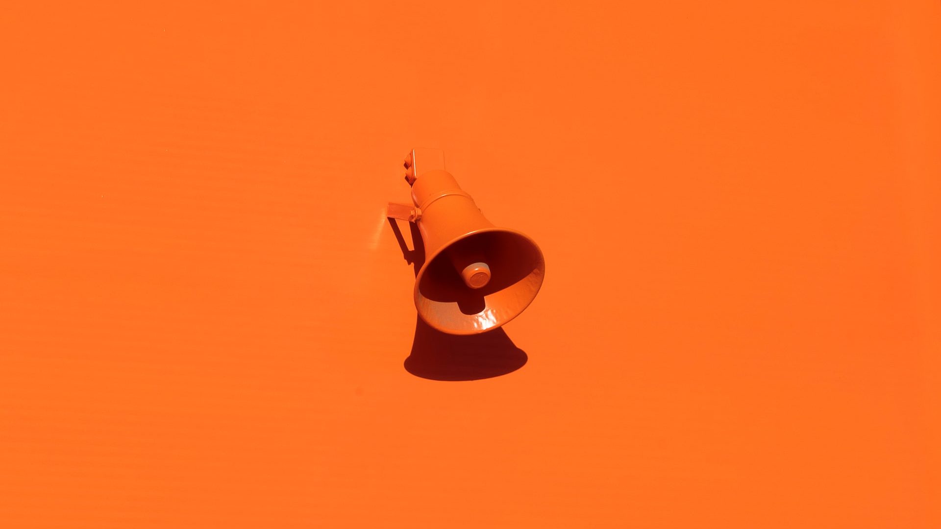 orange loudspeaker on orange wall