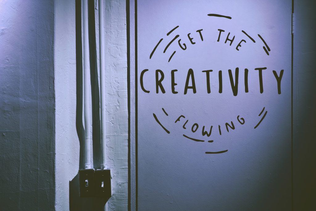 Get the creativity flowing written on a wall next to a light switch