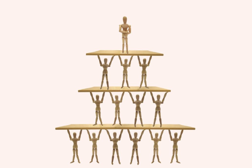 wooden statue of a human pyramid simbolizing social hierarchy