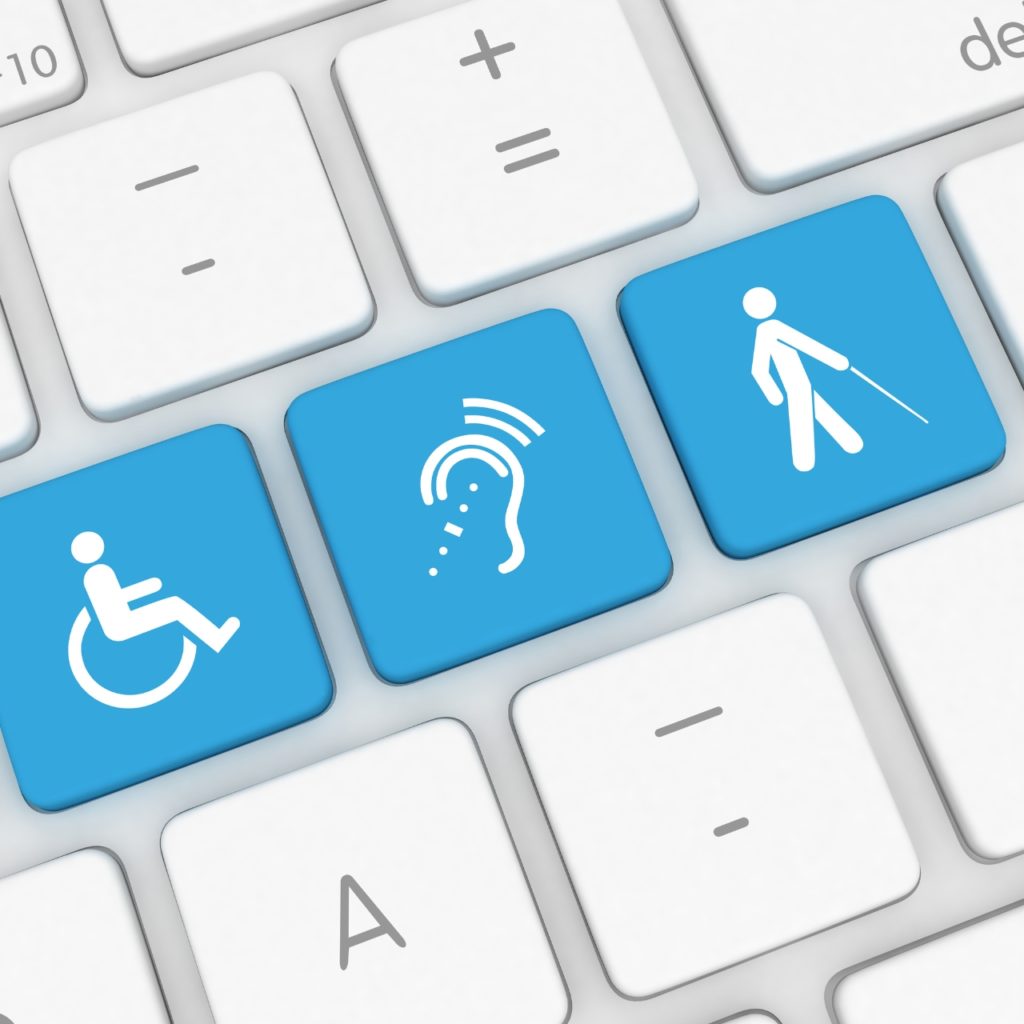 blue accessibility icons on white computer keyboard