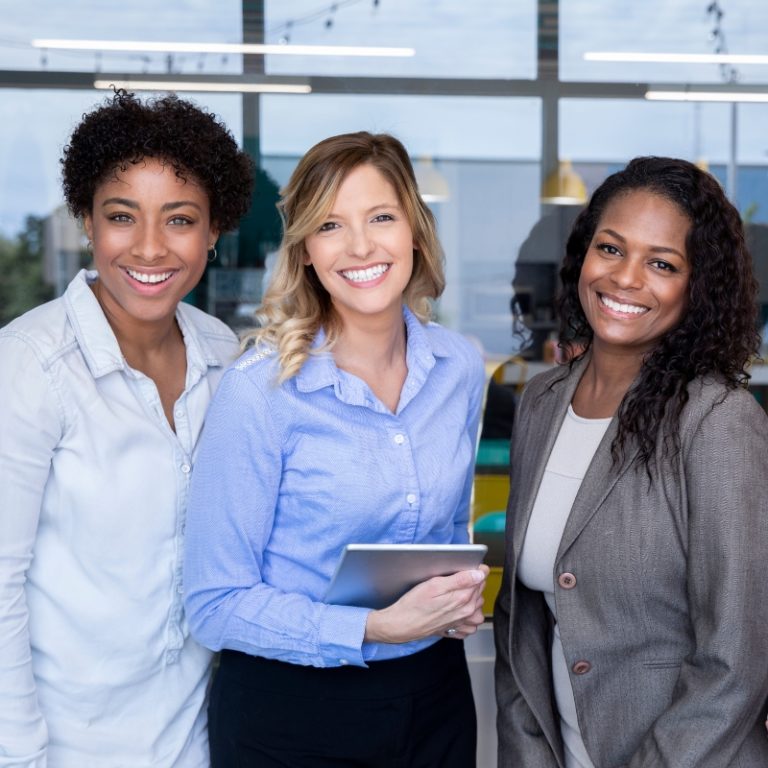 three professional women of which one is caucasian and the other two are african american